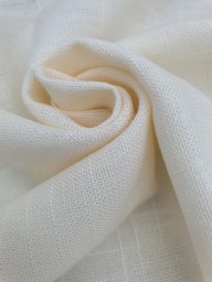 Cream linen fabric softly folded, showing natural texture and breathable weave – Vanessa May Designs