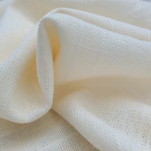 Cream linen fabric softly folded, showing natural texture and breathable weave – Vanessa May Designs